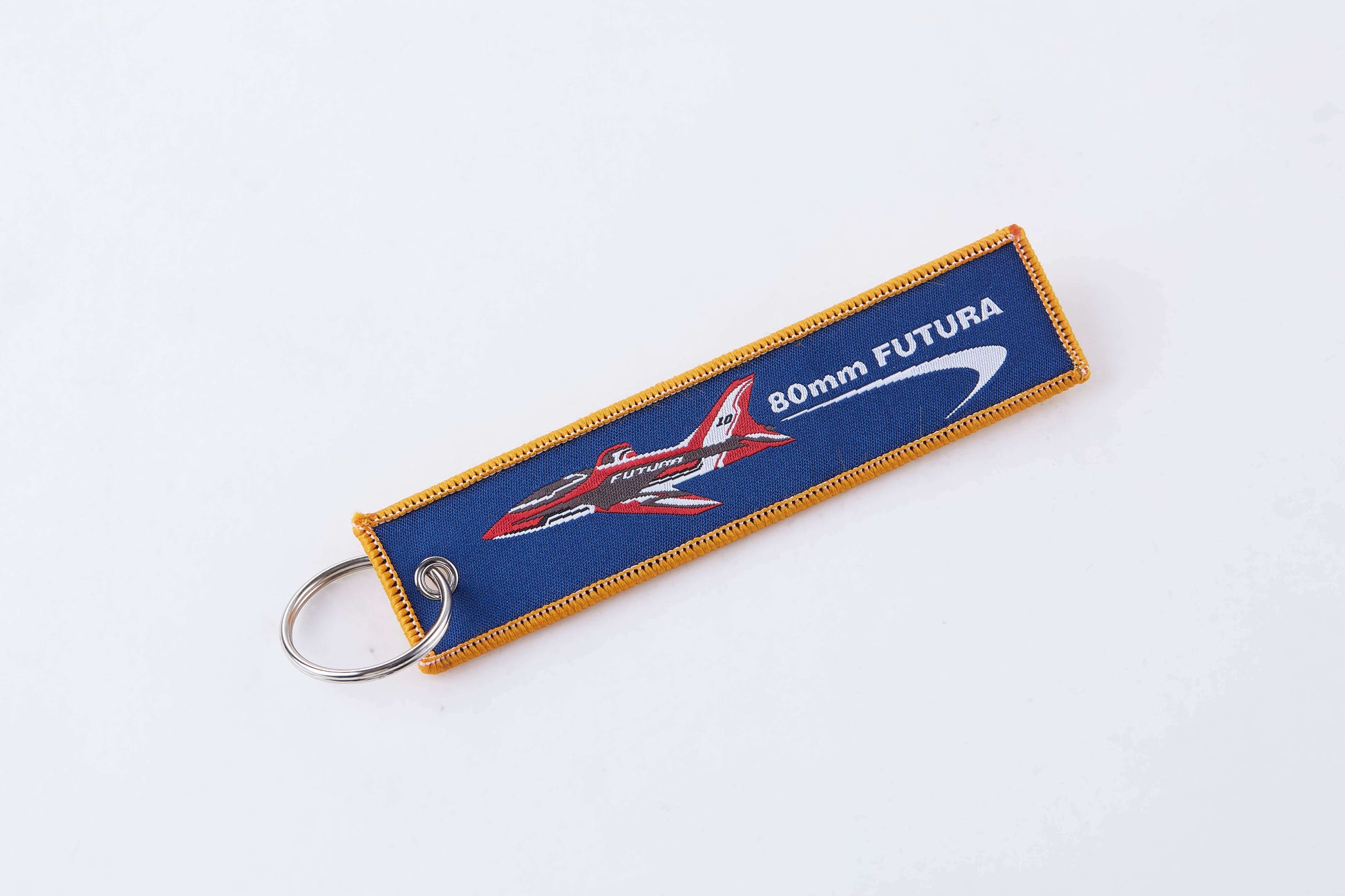 Blue keychain with airplane graphic and '80mm FUTURA' text for RC enthusiasts.