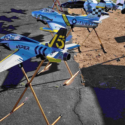 Multicolored RC airplanes on FMS Model Airplane Stand outdoors