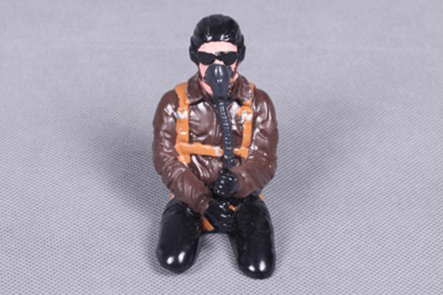 Kneeling pilot figurine with brown jacket and mask for RC models