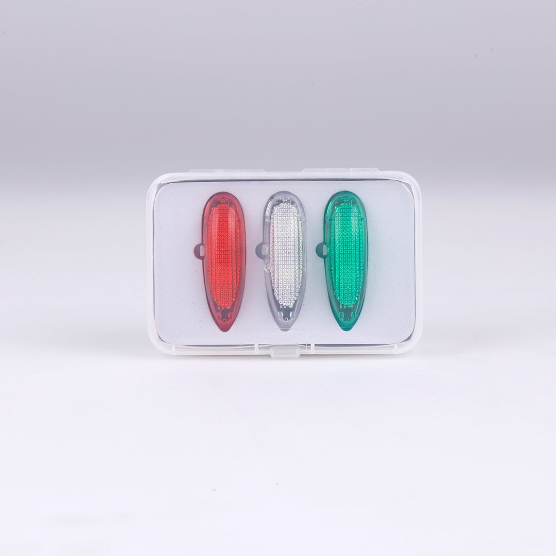 Three aviation lights: red, white, green in transparent packaging
