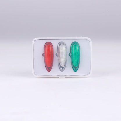 Three aviation lights: red, white, green in transparent packaging
