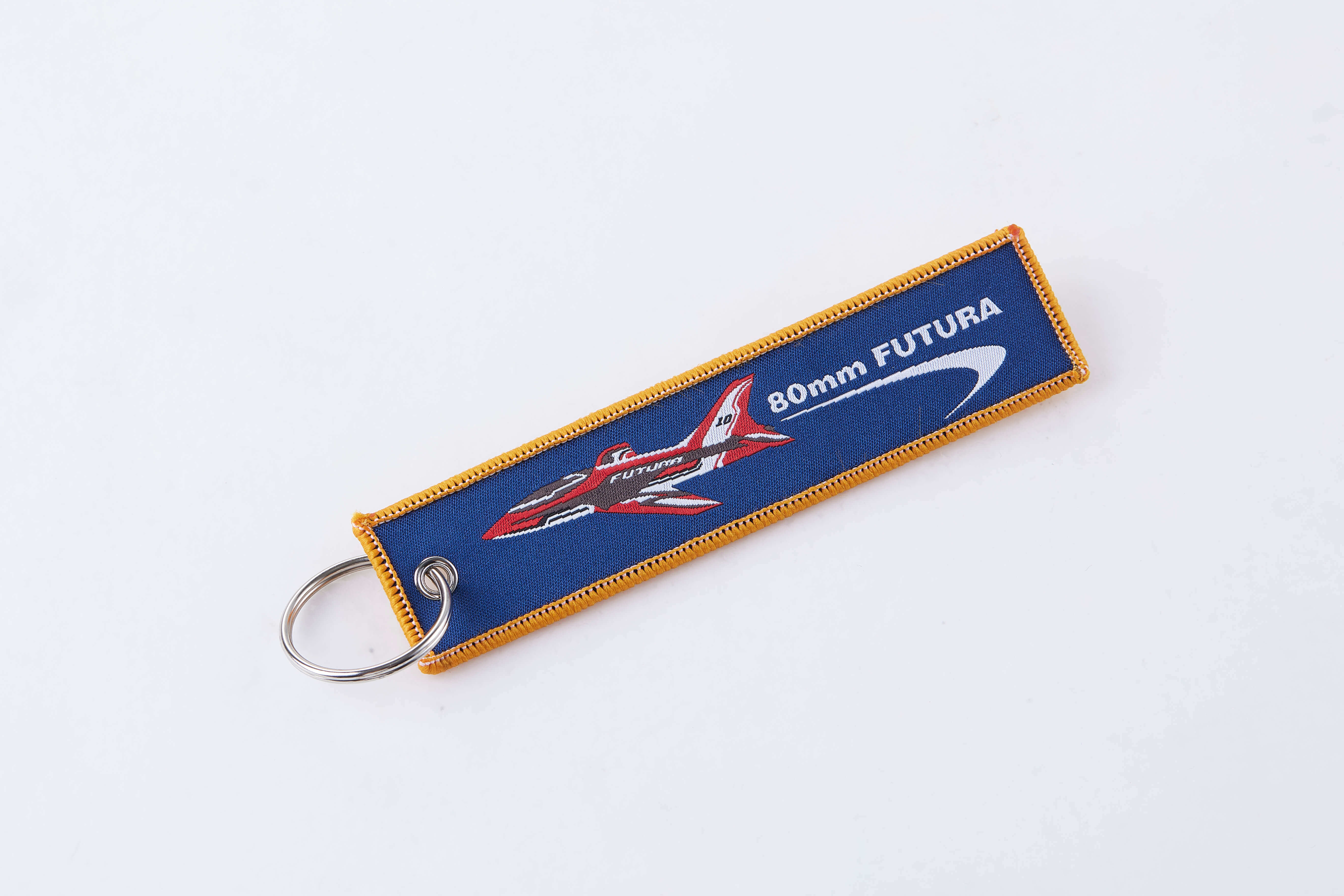 Blue keychain with airplane graphic and '80mm FUTURA' text for RC enthusiasts.