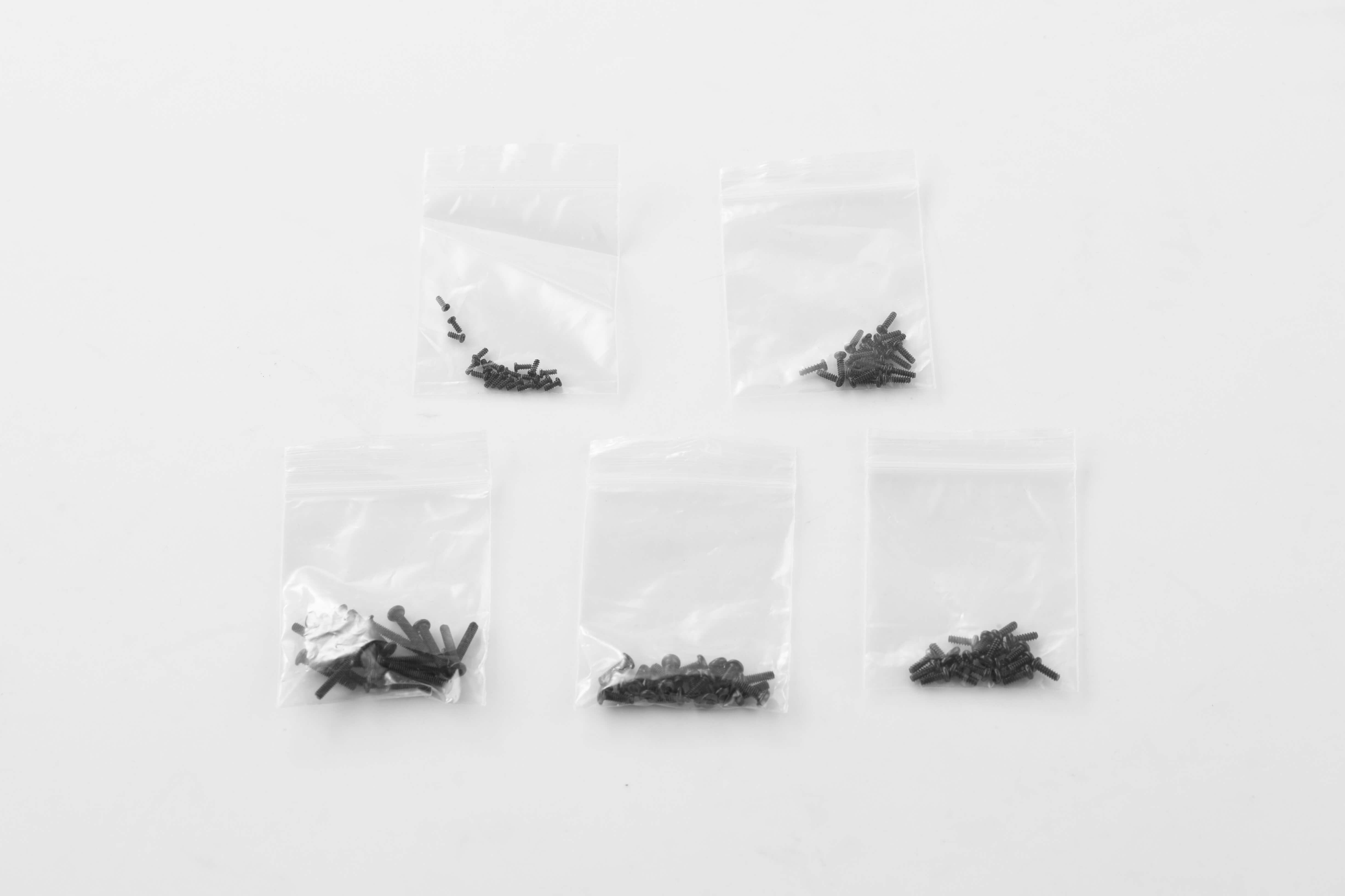 Small black screws and parts for 1:24 RC models in clear plastic bags